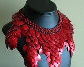 Intricate chainmaille collar in a striking anodized red.