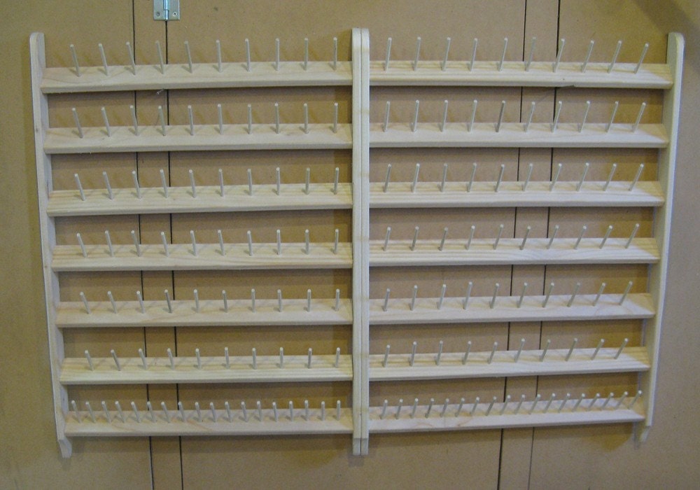 Sewing thread bobbin holder wall unit