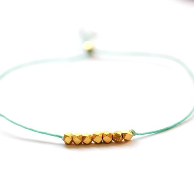 Wish bracelet beaded on sage green waxed linen cord with gold nuggets