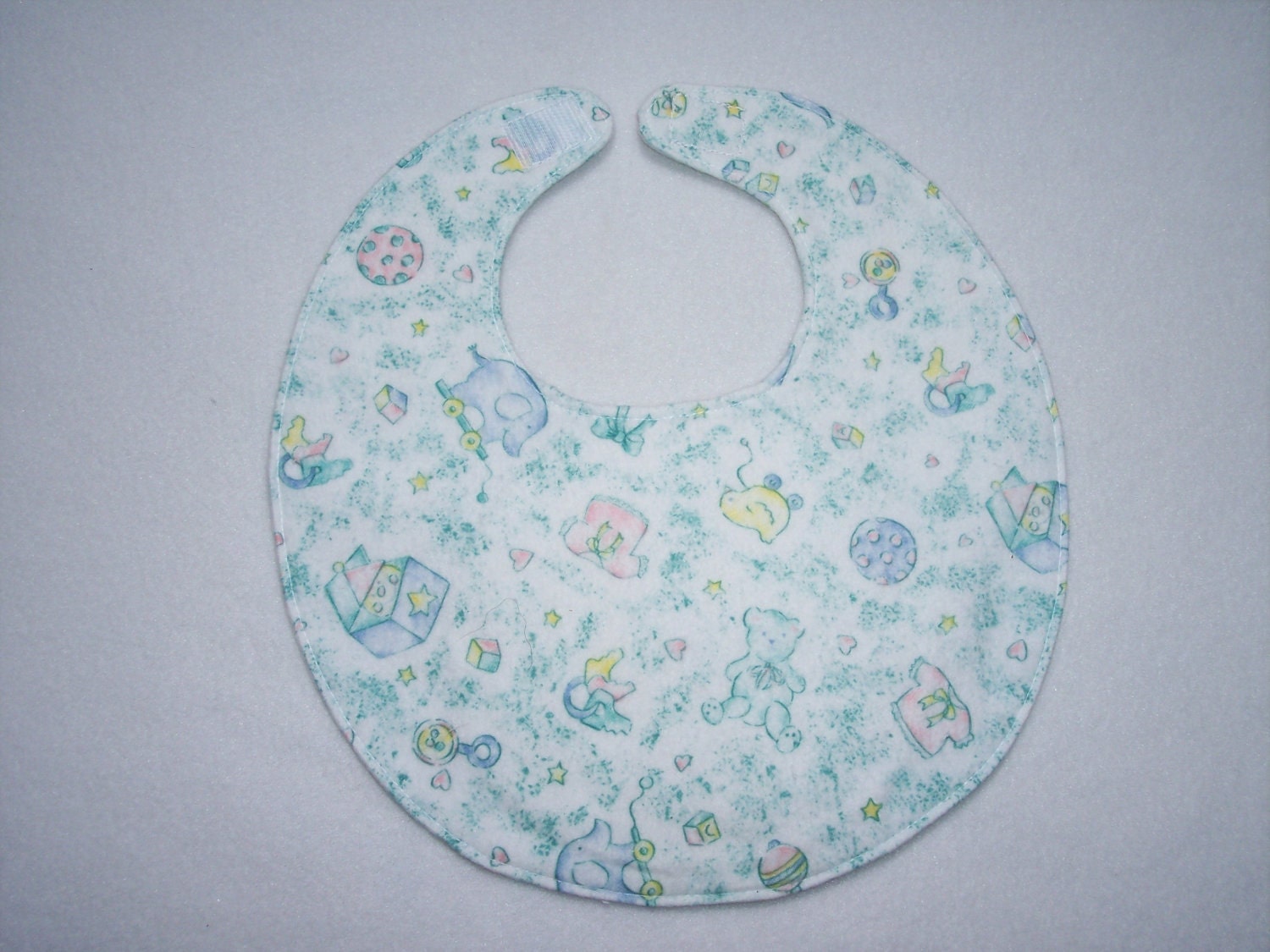 Baby Bib, four soft layers, reversible, white with pastel baby toys