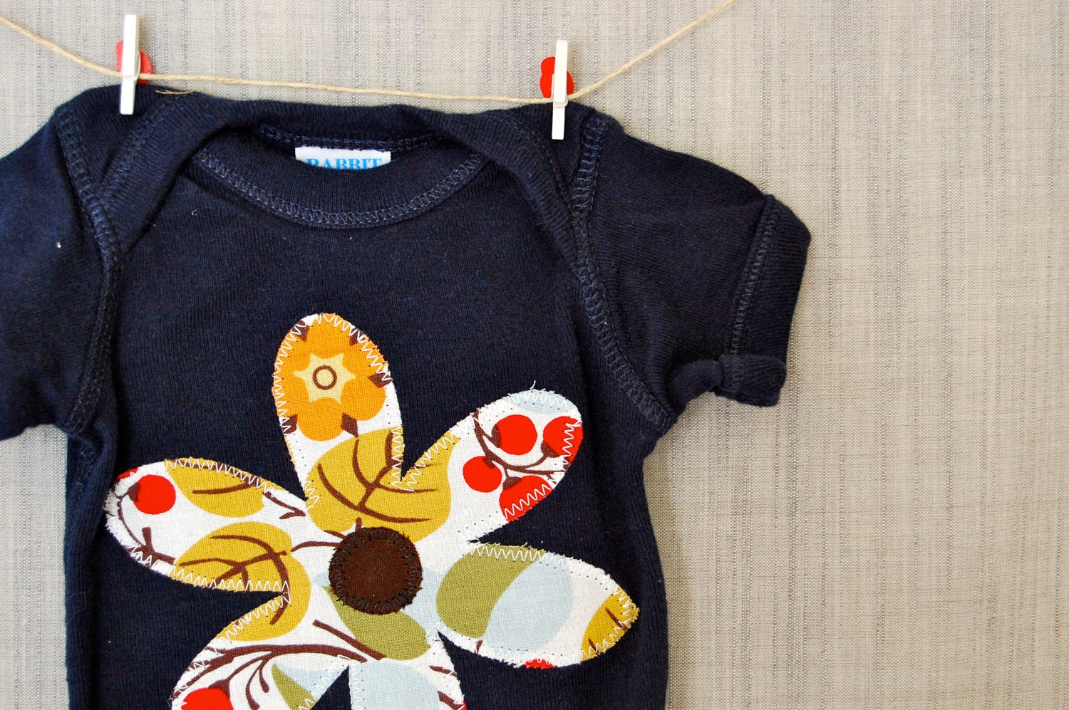 Baby girl onesie with flower