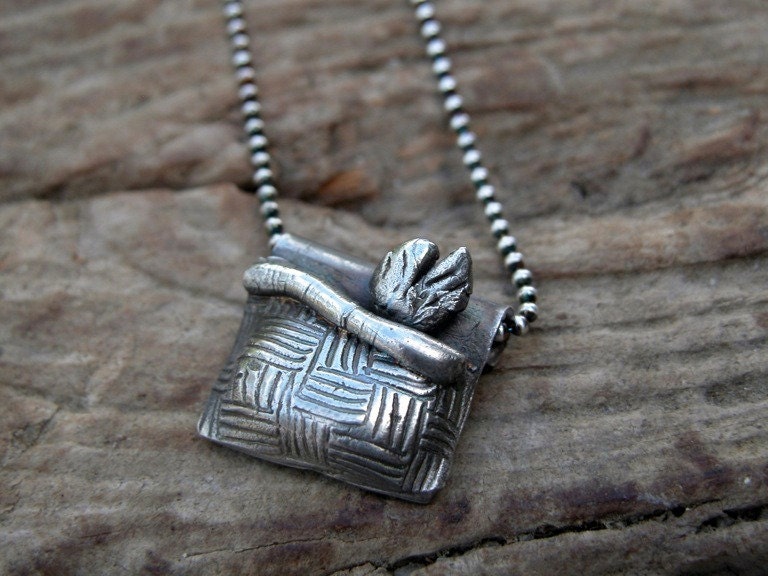 Silver fish in a basket pendant
