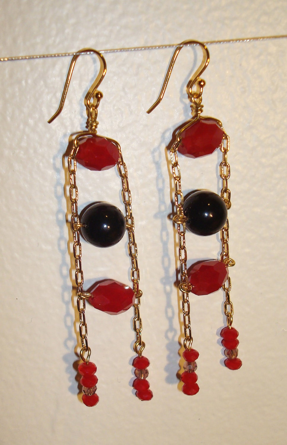 Jacob's ladder style drop earrings with magenta and black beads
