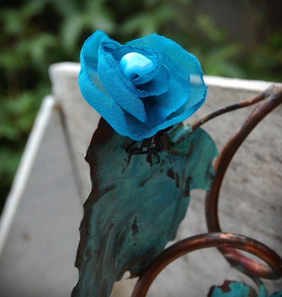 Handcrafted wearable art flower adjustable ring blues recycled fabric.