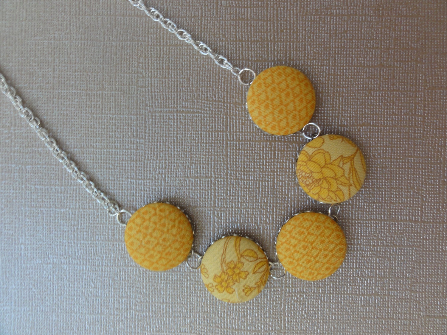Covered button necklace in Mustard - BipAndBop