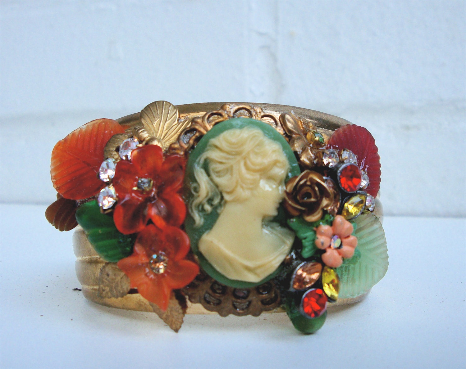 Vintage brass cuff bracelet with beautiful green cameo, flowers, leaves  and rhinestones