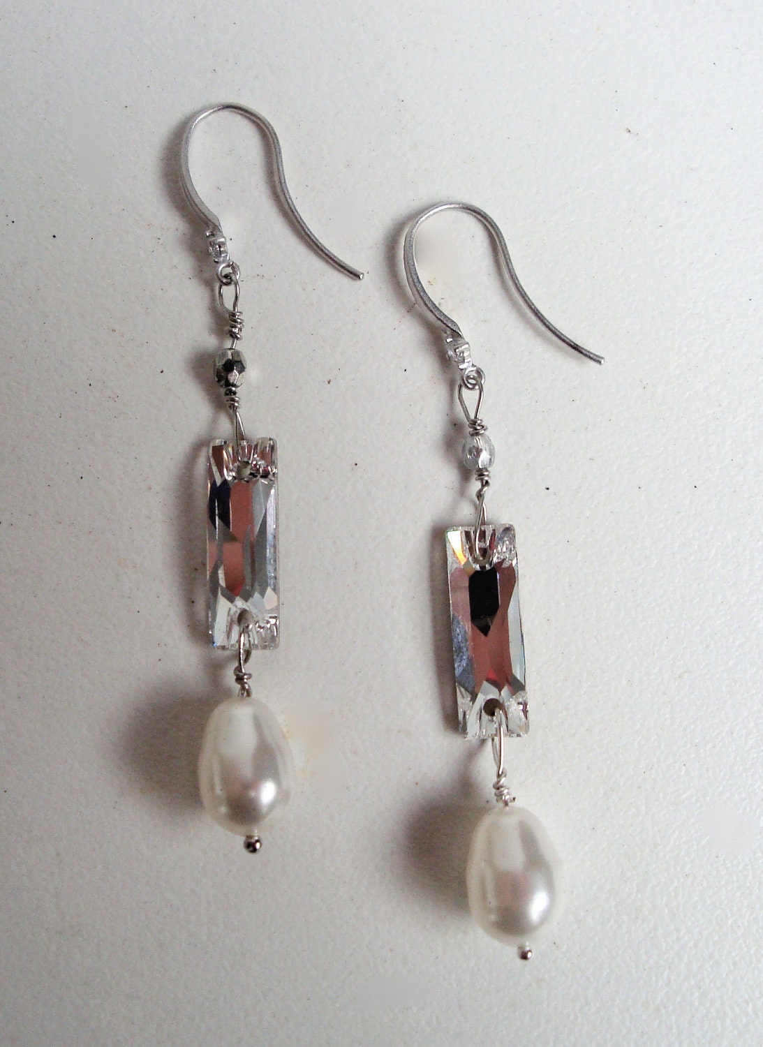Elegant Matte silver plated over brass cz ear wires with long swarovski crystal and swarovski pearl. Long and elegant earring
