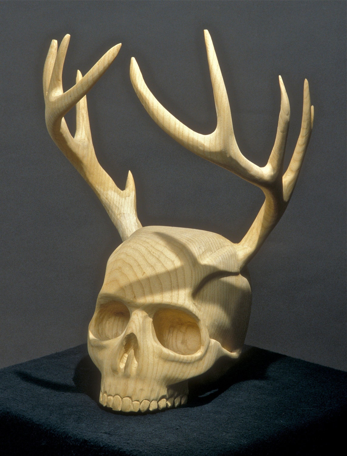 The Woodsman Urn by Jason Tennant. Carved wooden antlers and skull.