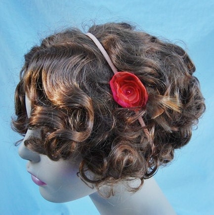 Handmade fabric flower red and orange adorned feathers beaded center on light peach elastic headband. perfect holiday gift