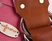 leather guitar strap in pink on brown