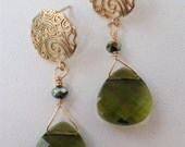 Matte gold vermeil earring with paisley design and sterling silver post with a beautiful olive green colored swarovski crystal briolette. 1
