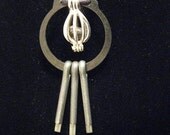 urban artifact necklace - dark gray Leland Lake Michigan slag glass, retaining ring, silver bead cage, cotter pins