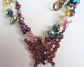 Vintage rhinestone butterfly  brooch converted to a pendant for this dyed fresh water pearl necklace with tiny swarovski crystals.