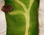 Mother nature has nothing on this green and ivory linen pillow with a home nest