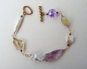 Beautiful and feminine natural gemstone bracelet consisting of fresh water pearls, amethyst, fluorite, whiskey quartz and swarovski crystals