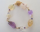 Natural gemstone bracelet consisting of Amethyst, Citrine ,Rough cut Rose Quartz, Pineapple Quartz, Calcite and Swarovski crystals