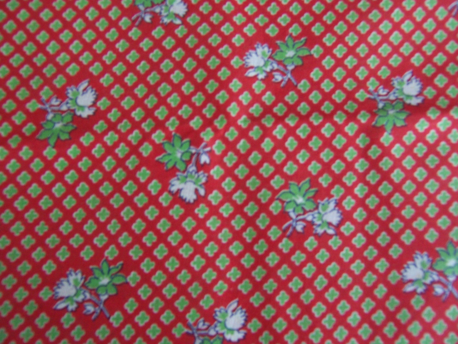 Antique vibrant red and floral feedsack material with green floral bouquets