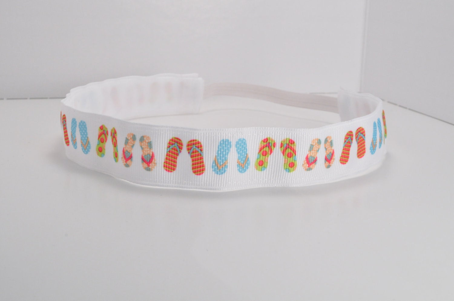 Band-It Headband .... Flip Flops.  Will stay put and not slip.