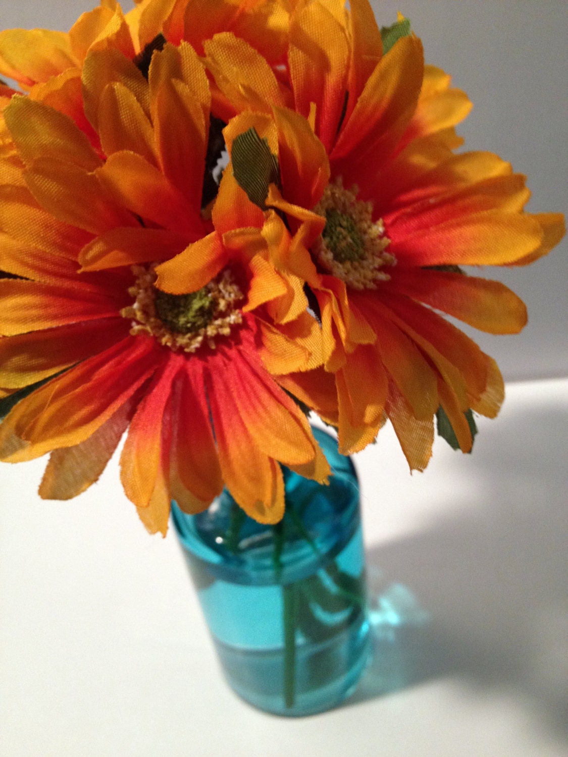 Blue Glass Vase with Orange Flowers