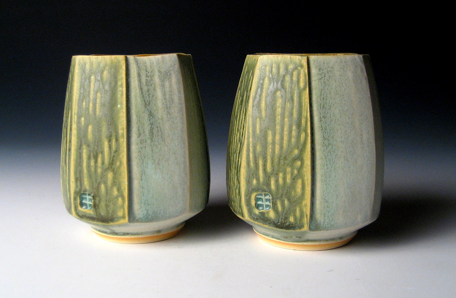 Pair of Squared and Carved Cups