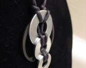 urban artifact necklace - three shiny washers in graduated sizes, black retaining ring