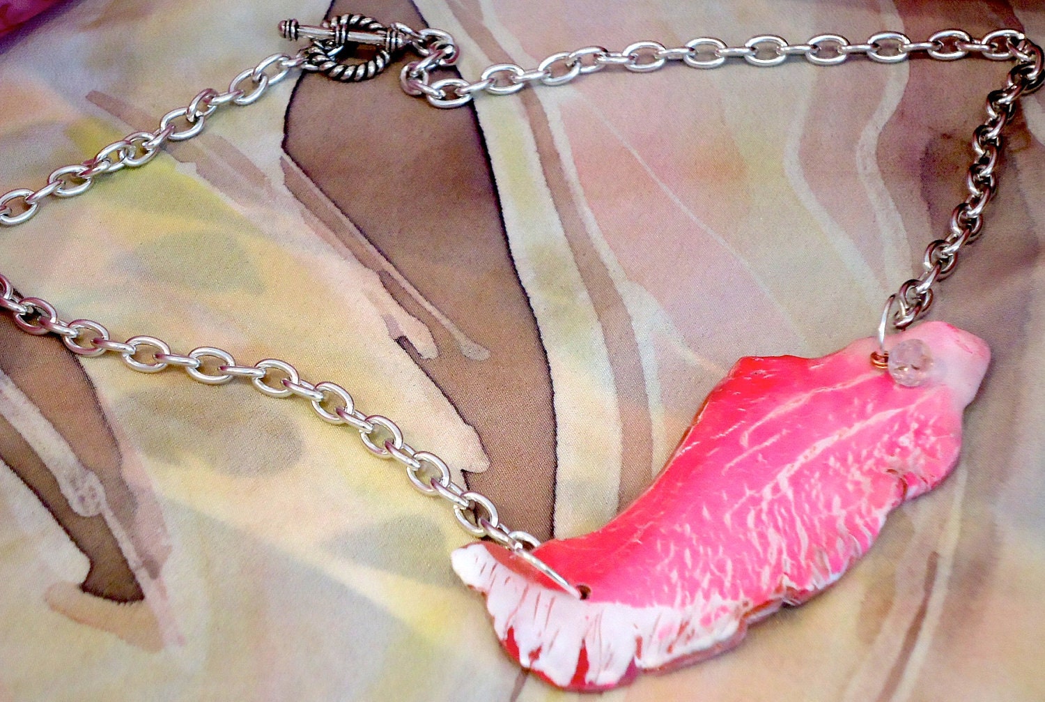 Pink wing necklace.