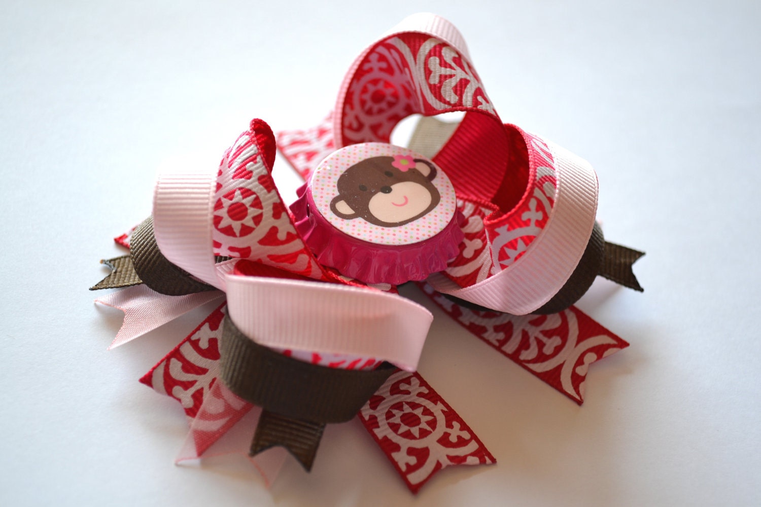 Adorable girl's monkey Bottlecap hair bow. Pink, white, brown.