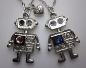 ROBOTS IN LOVE. Pair of Robot Necklaces in Silver Finish with Pink and Blue Swarovski.
