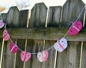 Butterfly garland crochet in light dark pink mauve and white. 40 inches long