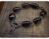 The Minion of Black Sulphur Springs . Smooth oval black Agate and Curious Antique Key Bracelet