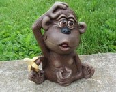 Ceramic Monkey holding a banana with his tail