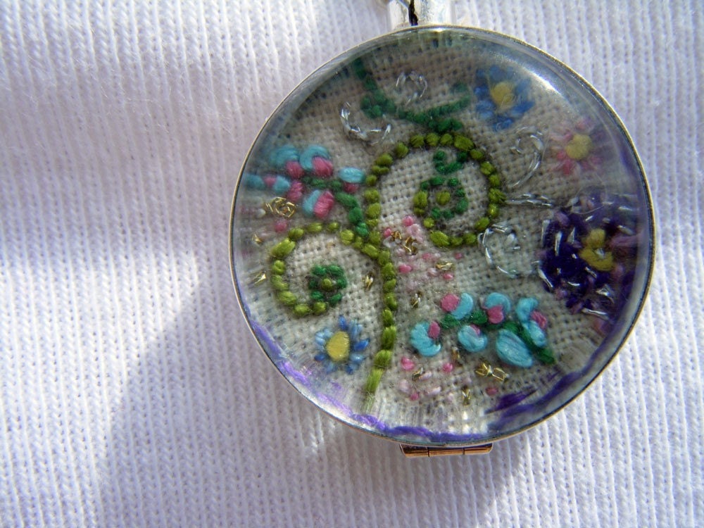 Hand embroidered  art piece 'Life is beautiful' in a two sided glass locket , Sterling Silver.