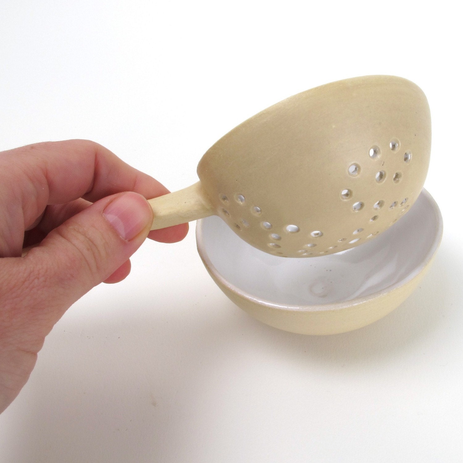 Beautiful tea strainer  with curled grip with a fitting bowl