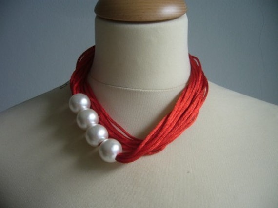 Red necklace with white pearls