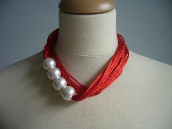 Red necklace with white pearls