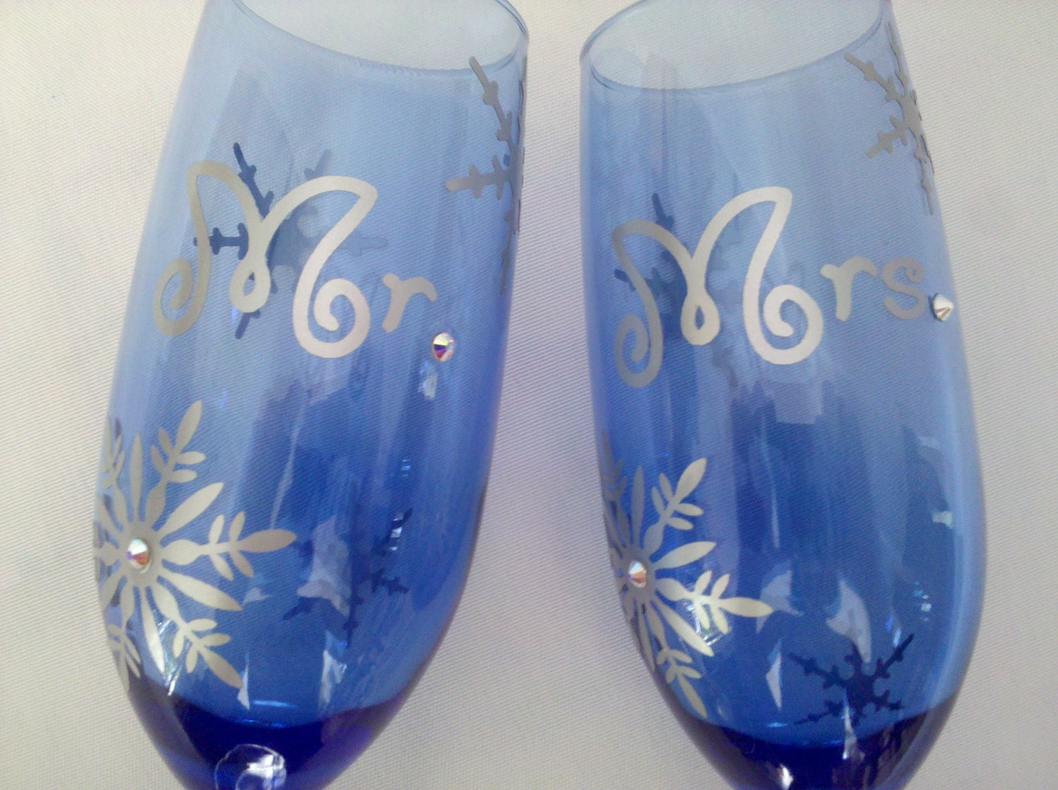 Mr. and Mrs. Christmas toasting flutes, unique champagne glasses for winter wedding.  Swarovski crystals and silver snowflakes