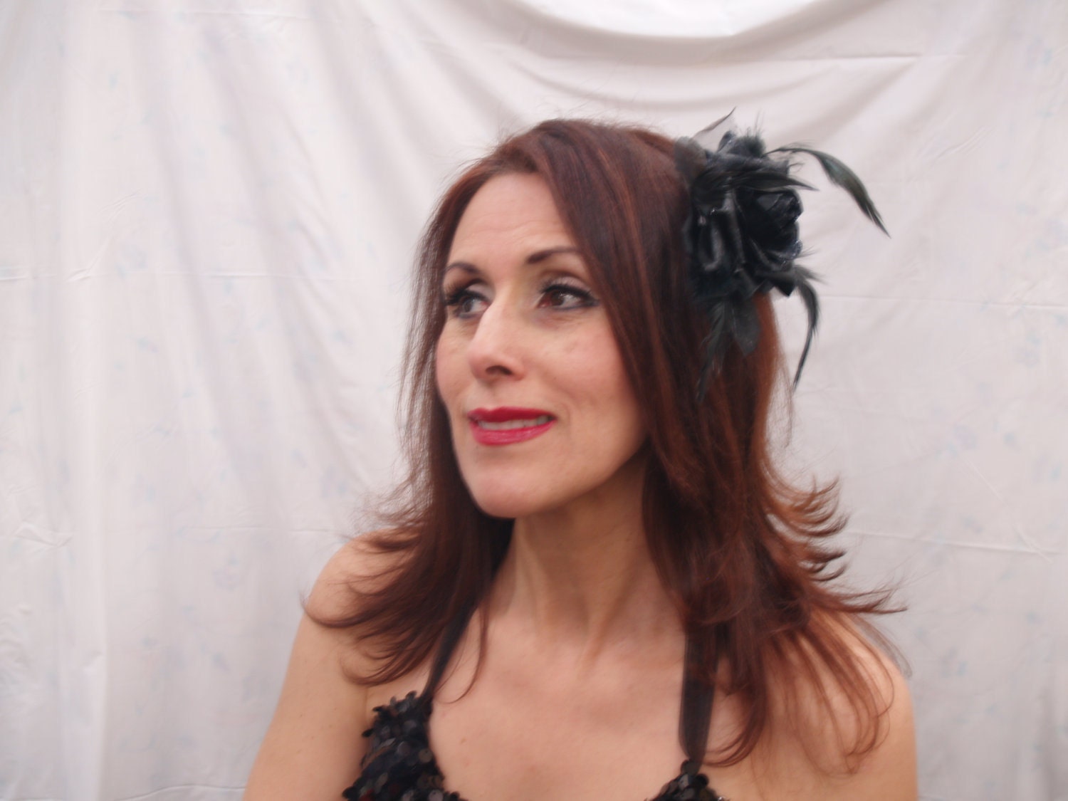 A Black Rose Head Piece with black feathers