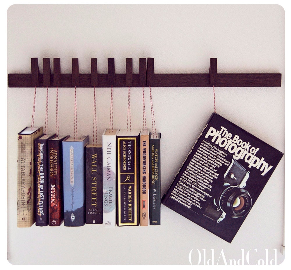 Custom made wooden book rack in Wenge. Movable pins.The pins also work as bookmarks.
