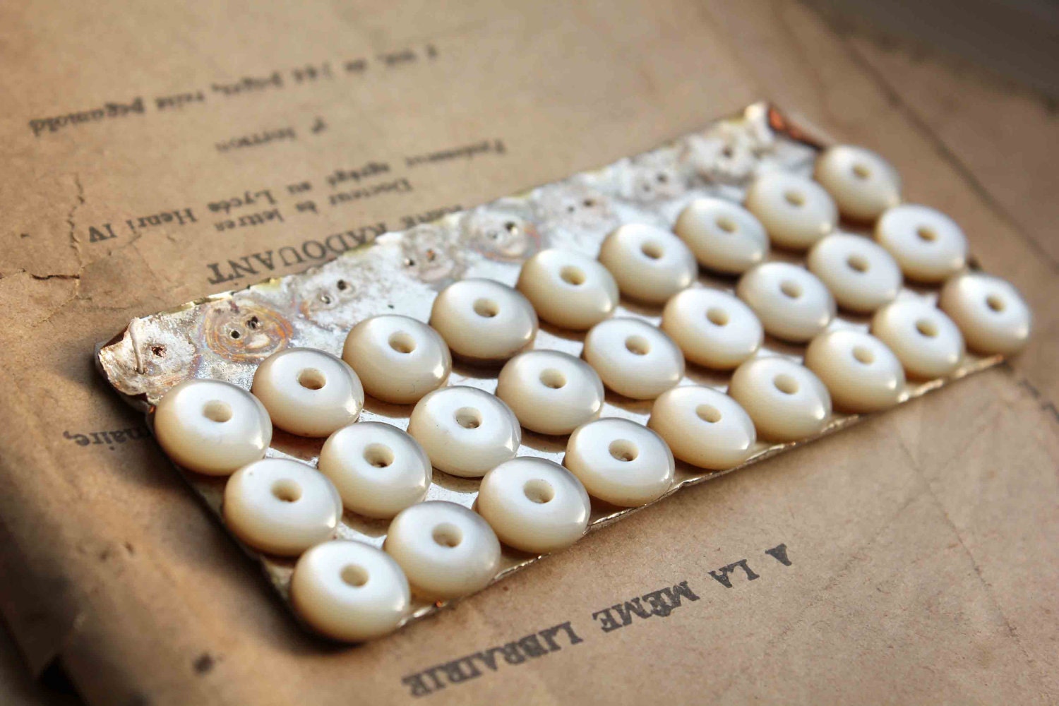 Antique French Mother of pearl buttons (27) sewn on their original card