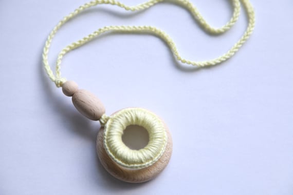 Teething rings nursing necklace with wooden olive, light yellow teething toy.