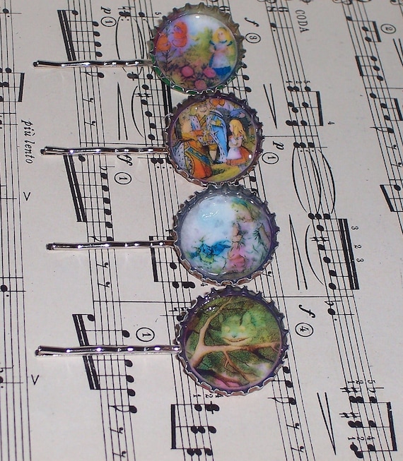 Four Alice in Wonderland-themed hair pins resting atop a sheet of music
