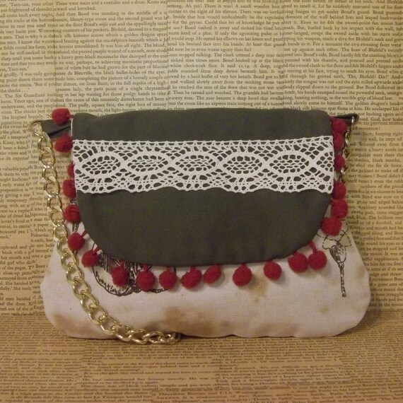 Pom pom and lace handbag with chain strap.