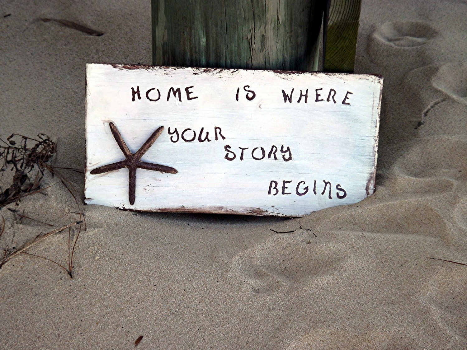 Handmade painted sign "Home is where your story begins"
