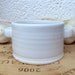 Deep Olive dish with two handles in White with a hint of pale blue celadon glaze