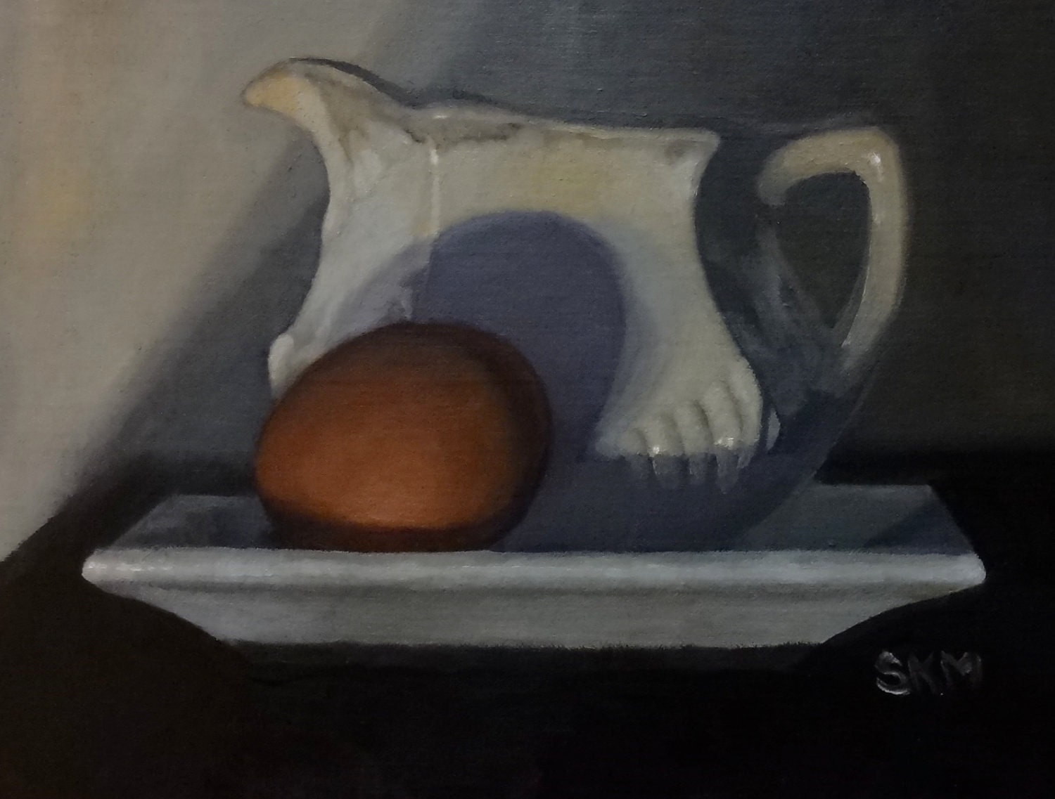 White pitcher, brown egg