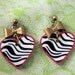 gold bow and zebra heart earrings