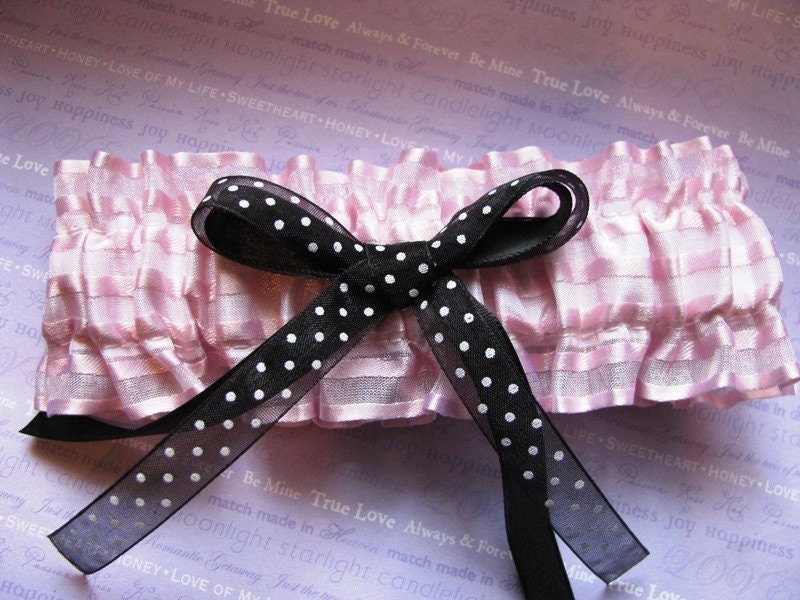 This is a simple light pink wedding garter with black and white polka dot 