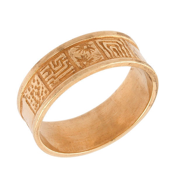 This handsome engraved artisan wedding ring in 14K rose gold features a
