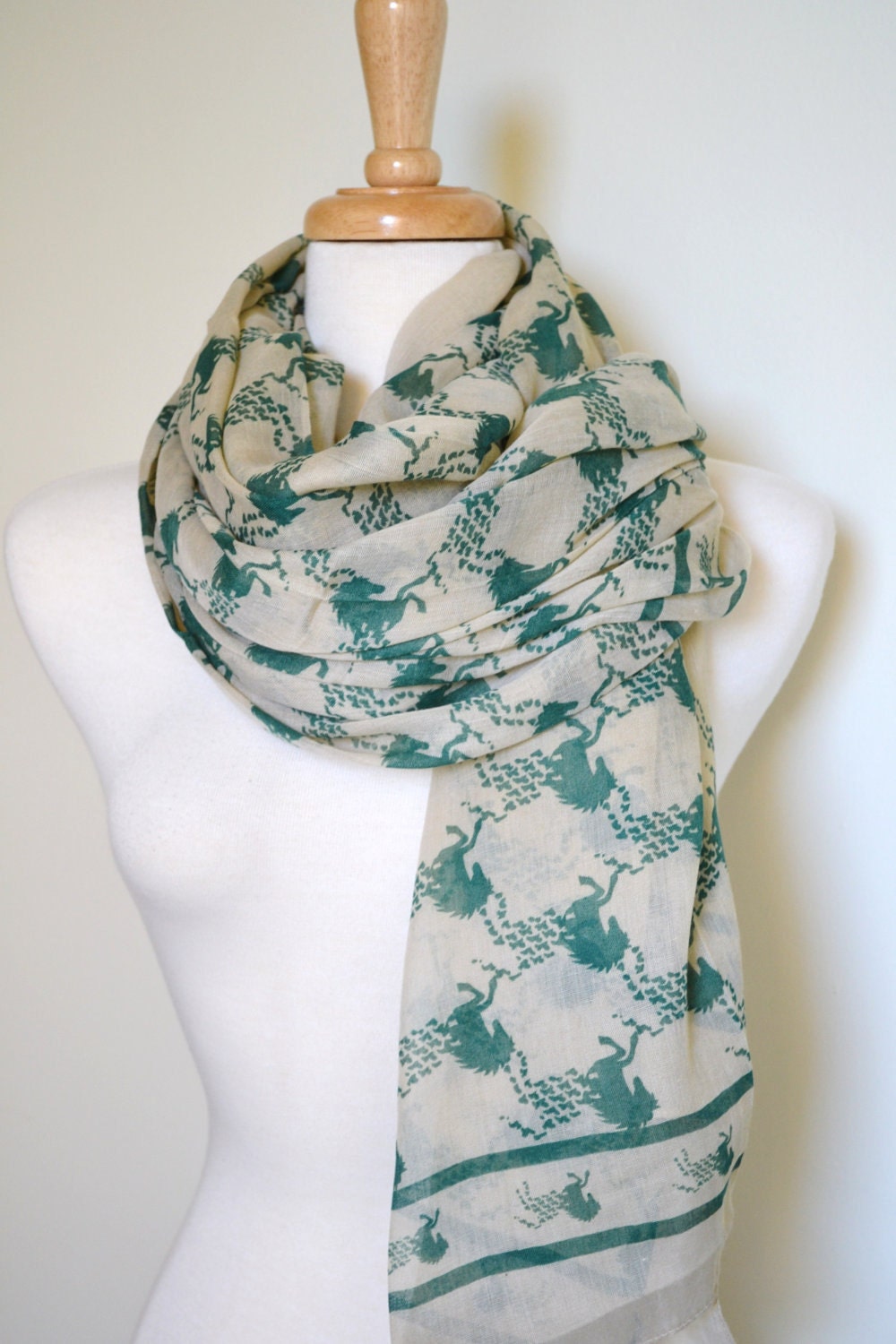 Scarf with images of green horses