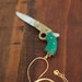 25% off sale plus Free Shipping with code BFCM12: Gun Pocket Knife Necklace with Emerald Green Bakelite Handle
